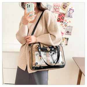 Detail of a brown Ita Bag with a clear window for badges and adjustable shoulder strap