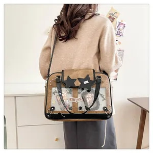 Brown faux leather ita-bag showing the transparent window and black star applique detail