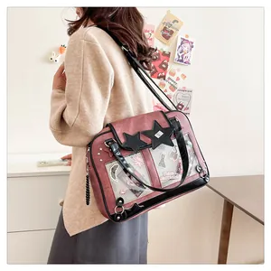 Detail of pink and black ITA bag with clear PVC window and star rivets in a lifestyle setting