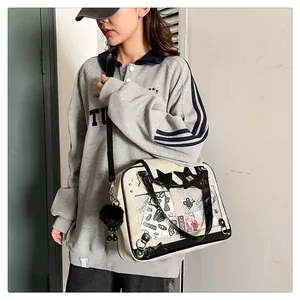 Detail view of beige canvas Itabag with clear window and black star patch accessory