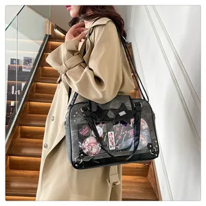 Fashionable dark grey ita bag with star rivets shown being worn by a model in lifestyle setting