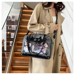 Detail view of transparent ita bag with black star patch and metal rivet decoration