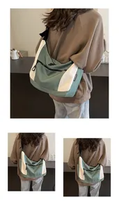 Detail of the high-density sage green and cream nylon crossbody bag on a model