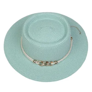 Detailed top view of mint green boater hat with metallic buckle and gold wind chain