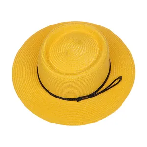Detailed weave texture of a yellow boater hat with black woven rope decoration