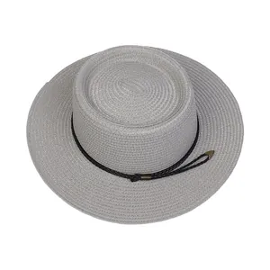 Detail of gray woven boater hat with black rope trim and metallic hardware accents