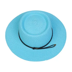Close-up of light blue woven straw hat with flat brim and decorative black cord detailing