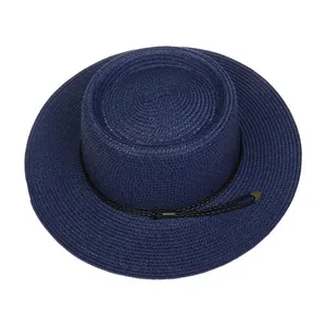 Detail of navy blue straw boater hat featuring fine spiral weave and black rope decor