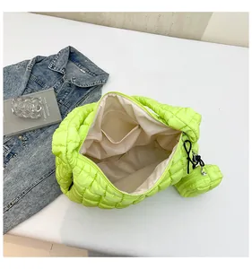 Macro detail of fluorescent green quilted cloud tote with matching round coin purse
