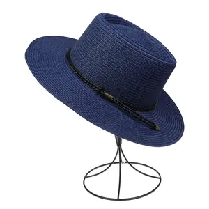 Detailed texture of navy woven straw hat with black rope and copper fastener detail