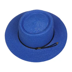 Detail of royal blue straw boater hat featuring woven texture and black decorative cord