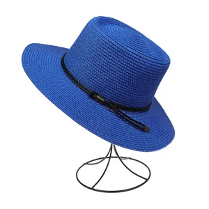 Detail of royal blue woven sun hat with black ribbon trim and textured straw finish