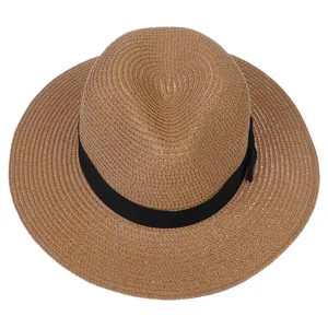 Vue de dessus montrant le tissage serré d'un chapeau Panama en paille marron à ruban noir