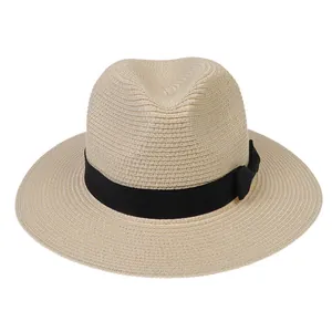 Détail du tissage en paille d'un chapeau de soleil avec ruban noir et nœud