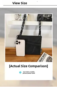 Close-up of black mesh crossbody bag with woven strap showing phone storage capacity