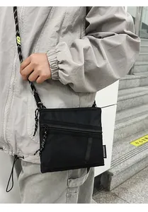 Detail of nylon crossbody bag with mesh pocket and black white woven rope strap