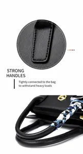 Close-up of black leather handbag featuring reinforced stitching and scarf-wrapped handle