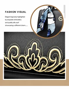 Detail of lychee textured leather bag with golden embroidery and silk scarf decoration