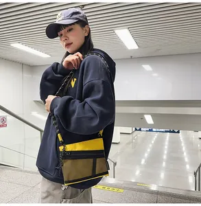 Street style nylon crossbody bag in yellow and black featuring mesh pocket and woven strap