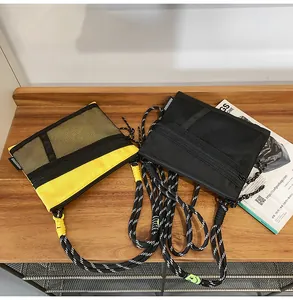 Detail of waterproof nylon crossbody bags with mesh pockets and woven rope straps