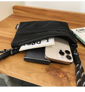 Detail view of the black nylon crossbody bag interior showing spacious storage compartments