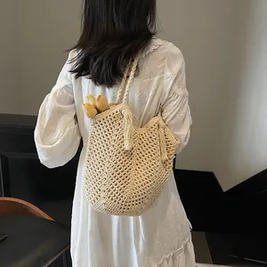 Handcrafted woven tote bag with fringe detail and hollow mesh design for women