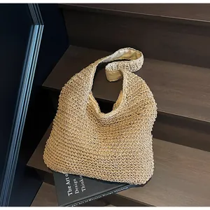 Close-up of woven straw tote bag texture and wide strap on wooden stairs