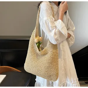 Detail of hollow woven straw tote bag with inner lining and large capacity