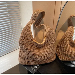 Detailed texture of bohemian handwoven straw tote bag with brown crochet pattern