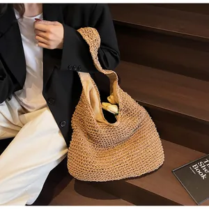 Detail of woven straw hobo bag showing intricate texture and spacious tote interior