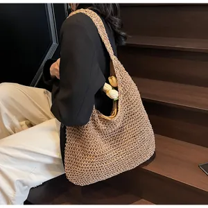 Detailed texture of hand-woven straw tote bag with natural khaki mesh weave pattern