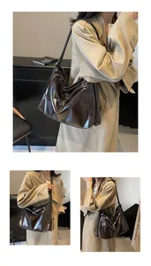 Détail du grand sac cabas en cuir marron foncé brillant avec plis souples et fines anses