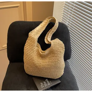 Detail of beige straw tote bag with woven texture on a textured velvet chair