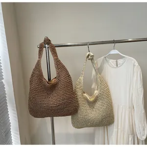 Detailed close-up of woven straw tote bags showing texture and knotted strap design