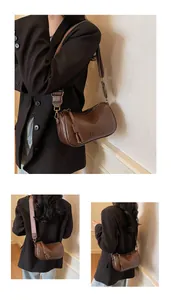 Detail of vintage dark brown faux leather hobo bag with ethnic jacquard wide strap