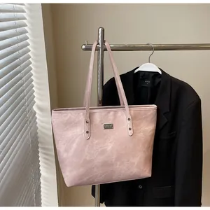 Macro view of pink tote bag showing faux marble texture and silver metallic logo