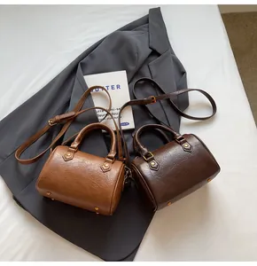 Detail of Boston bag showing retro gold hardware and durable荔枝-texture synthetic leather