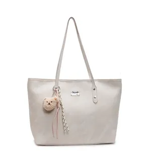Large beige commuter tote bag with leather texture and cute plush bear charm