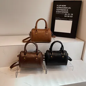 Vintage Boston barrel bags in three colors with gold studs and adjustable straps