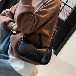 Classic black vintage pillow bag with textured leather and gold-tone hardware details