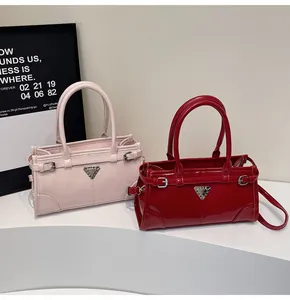 Detail view of pink matte and red glossy tote bags with metal triangle logo and dual handles