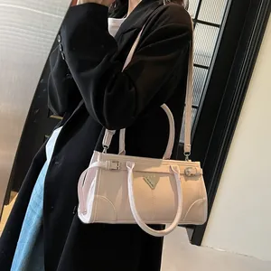 Chic light pink tote bag with triangular metal logo and detachable shoulder strap for women