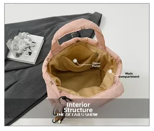Pink quilted bucket bag interior showing main compartment and zippered side pocket