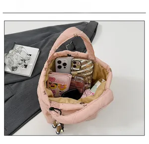 Detailed interior of pink quilted bucket bag showing large capacity and magnetic closure