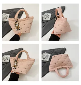 Detailed views of a pink quilted puff bucket bag featuring delicate bow embroidery