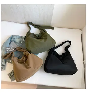 Detailed view of nylon drawstring tote bags in army green, khaki and black colors