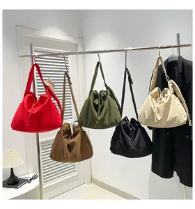 Detail showing colorful drawstring tote bags with wide adjustable shoulder straps