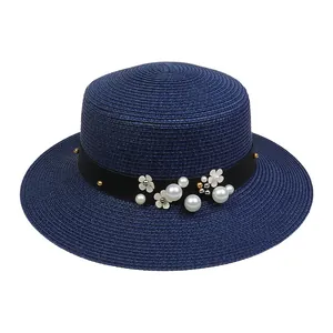 Dark blue woven boater hat featuring elegant white pearl and flower embellishments