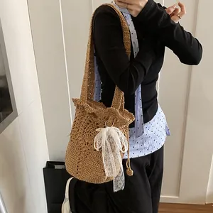 Handmade woven bucket bag with elegant lace bow and pearl charm for summer vacation