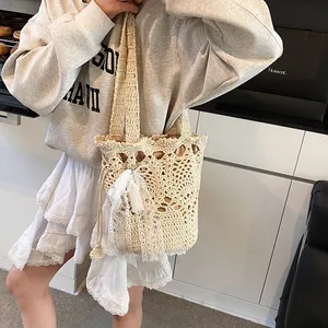 Chic beige crochet bucket bag with hollow woven patterns and a large lace bow accent